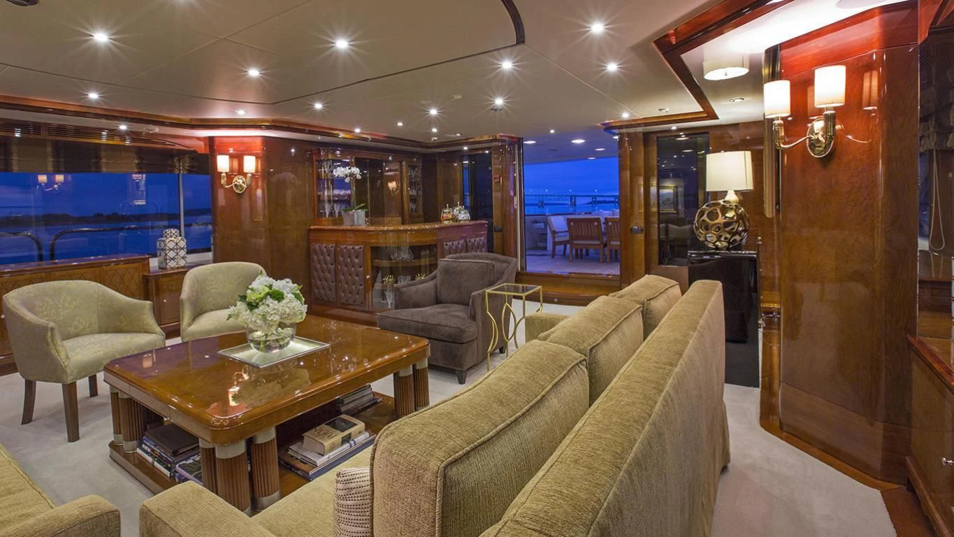 a living room with a couch and a coffee table aboard DOMANI Yacht for Sale