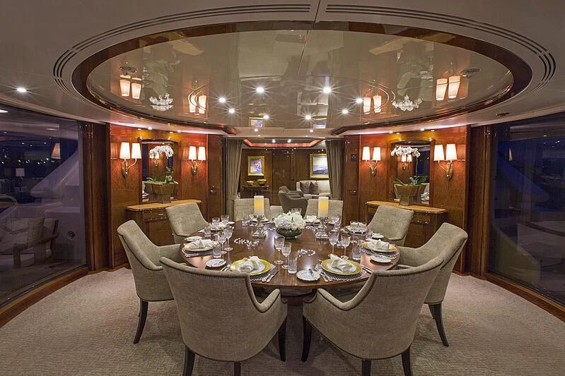 a dining room with a table set aboard DOMANI Yacht for Sale