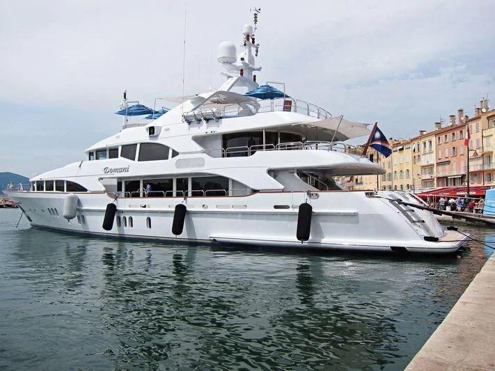 a white yacht on a river aboard DOMANI Yacht for Sale