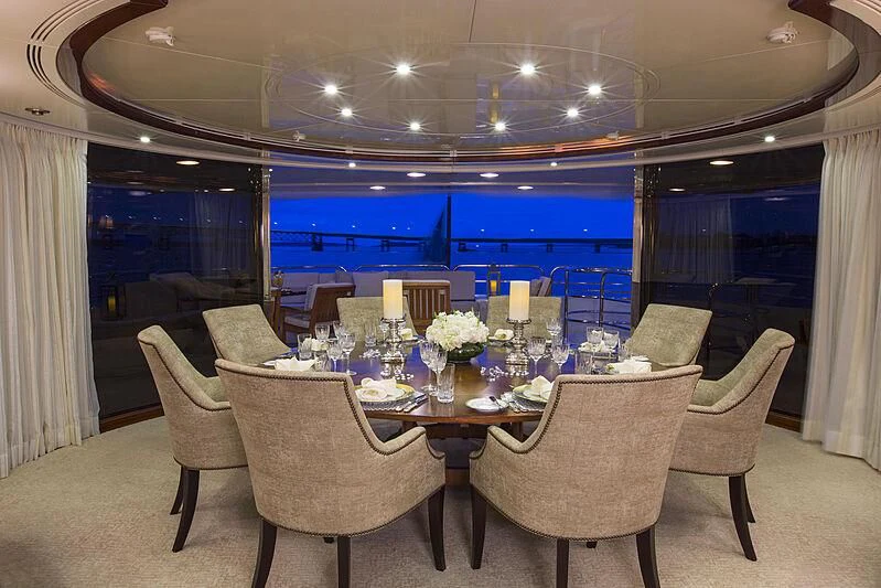 a table set for a dinner party aboard DOMANI Yacht for Sale
