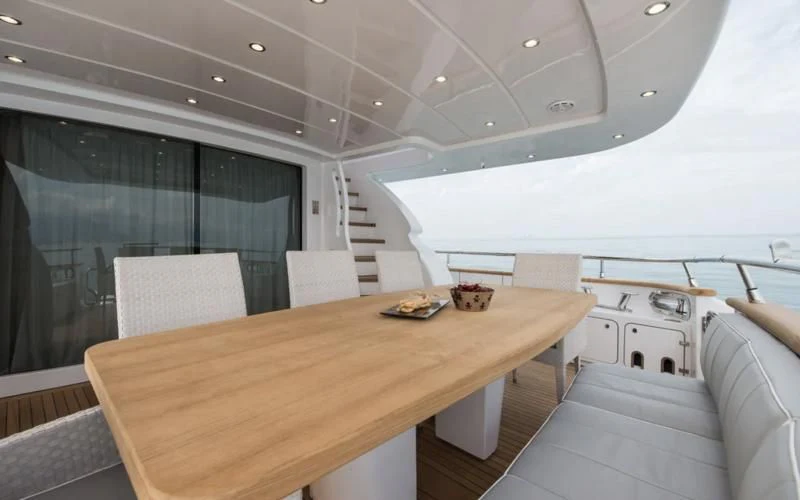 a room with a table and chairs aboard MIREDO Yacht for Sale