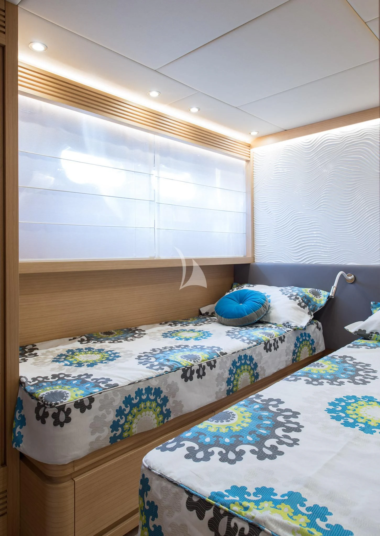 a bed with a blue pillow aboard MIREDO Yacht for Sale