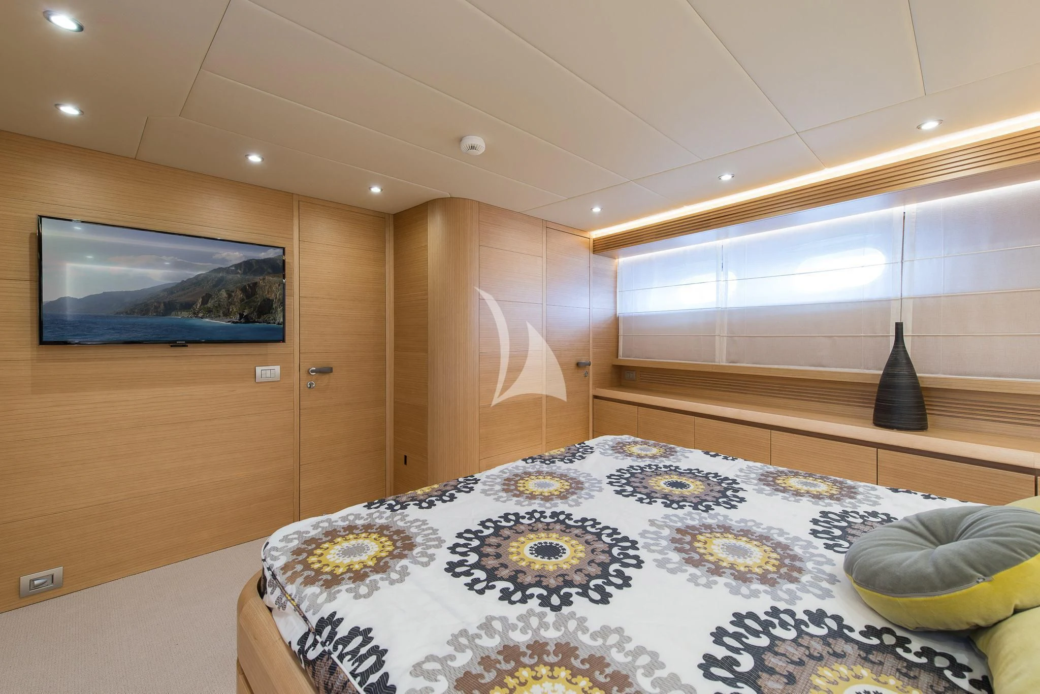 a room with a bed and a tv on the wall aboard MIREDO Yacht for Sale