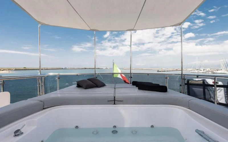 a boat with a flag on the front aboard MIREDO Yacht for Sale