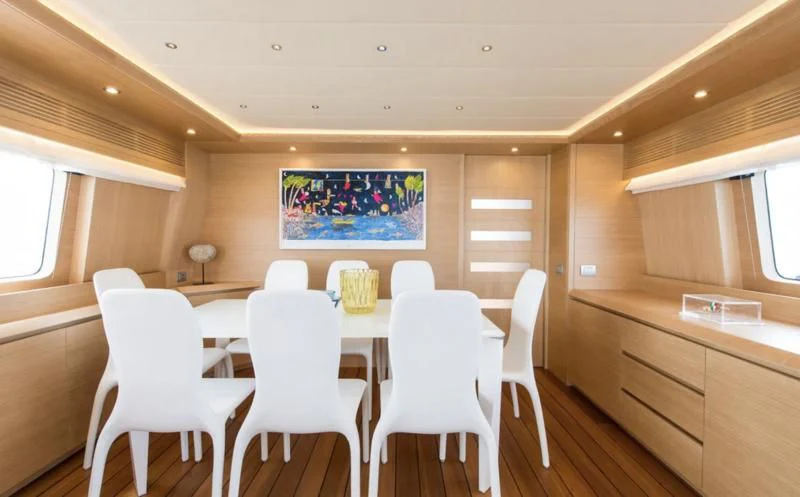 a room with a table and chairs aboard MIREDO Yacht for Sale