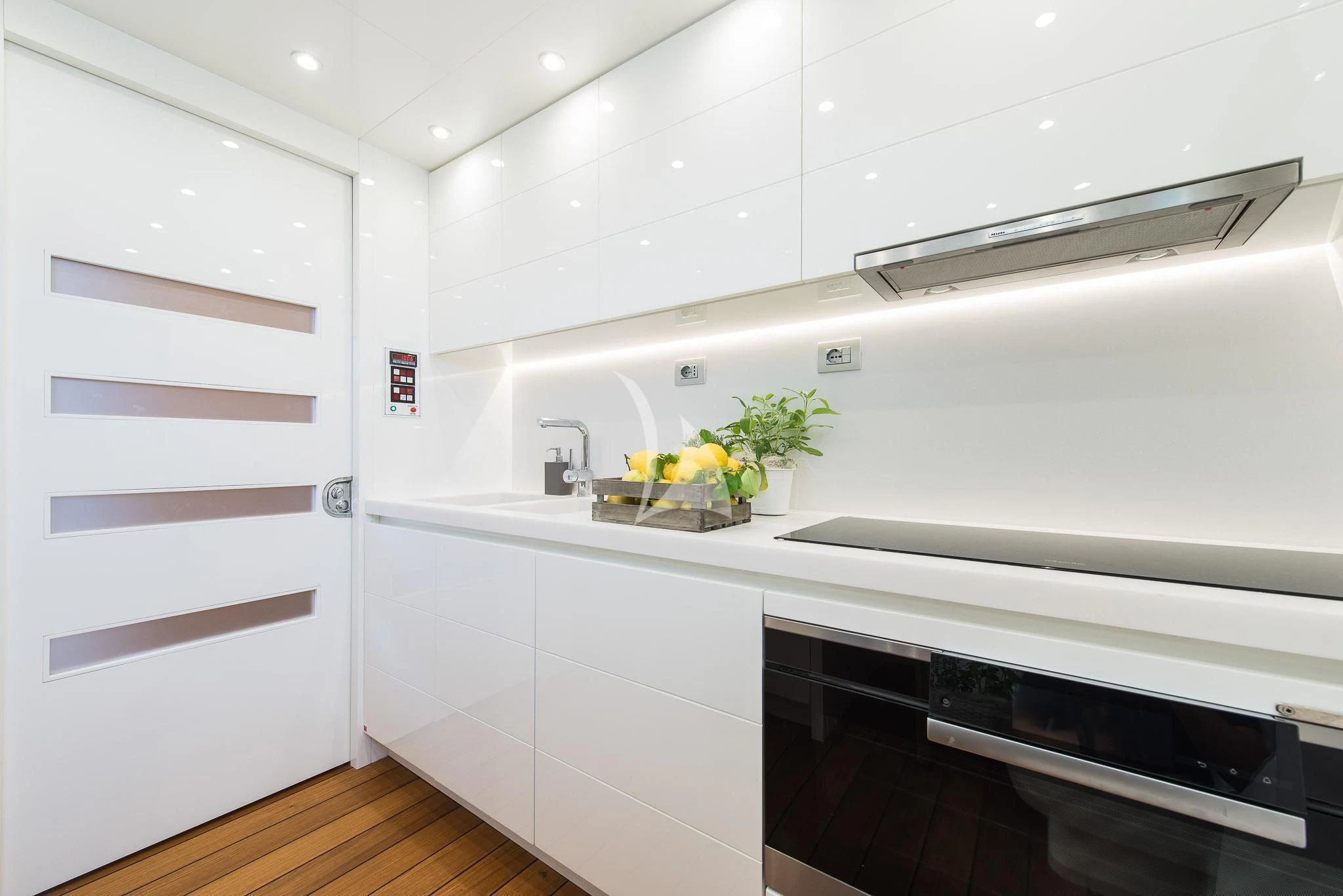 a kitchen with white cabinets aboard MIREDO Yacht for Sale