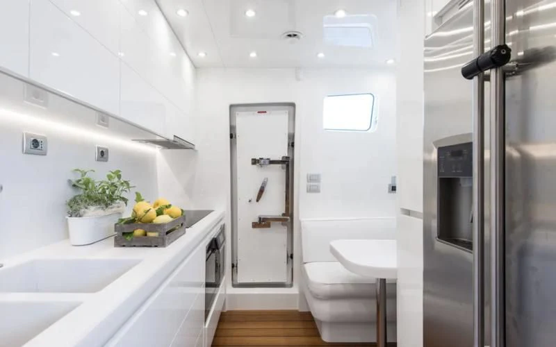 a kitchen with a sink and a refrigerator aboard MIREDO Yacht for Sale
