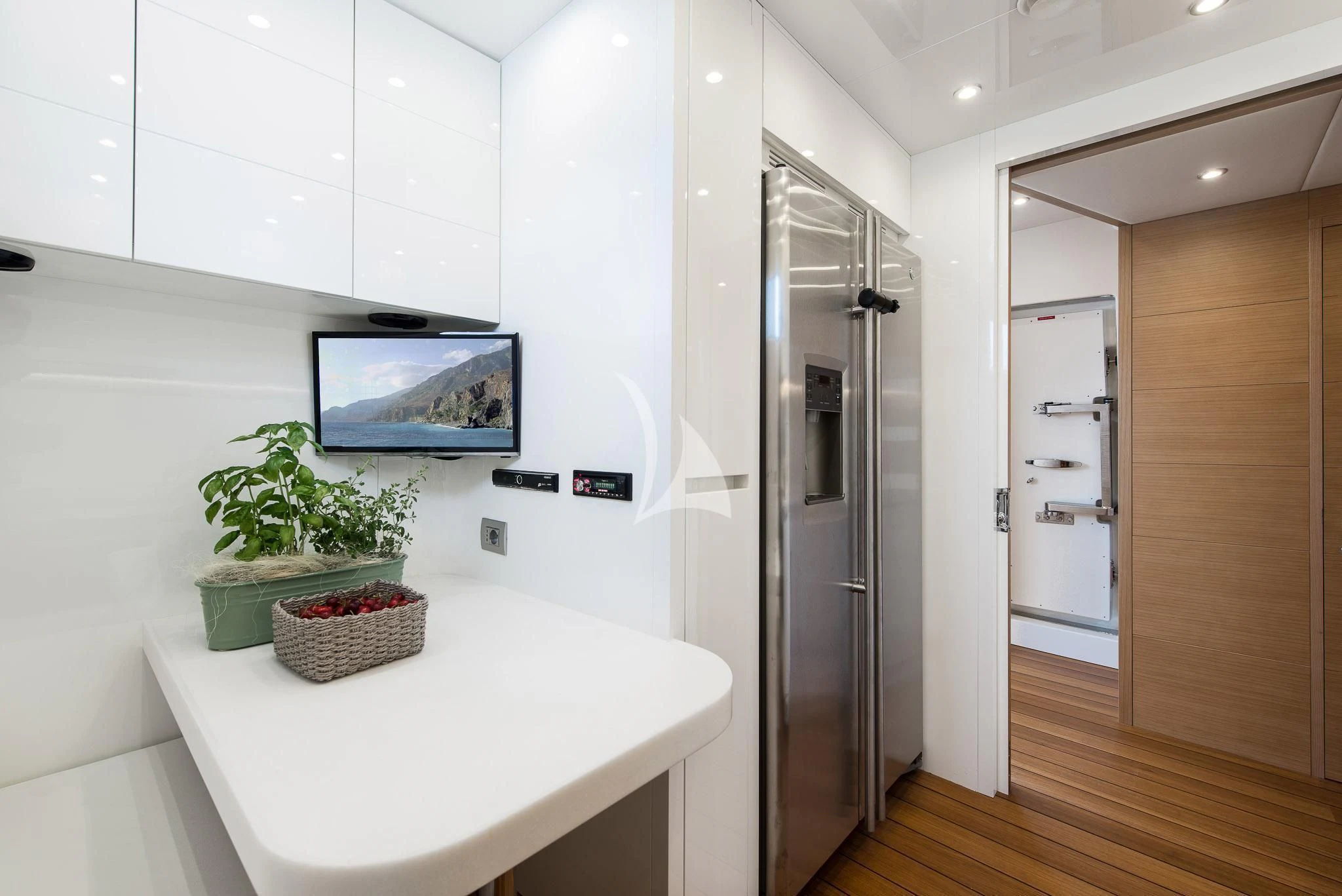 a white room with a table and a plant in a pot aboard MIREDO Yacht for Sale