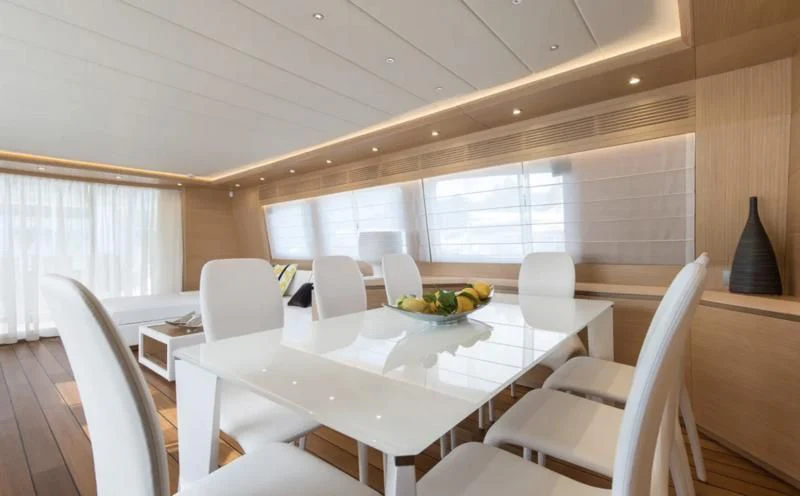 a dining room with white chairs and a large table with white chairs aboard MIREDO Yacht for Sale