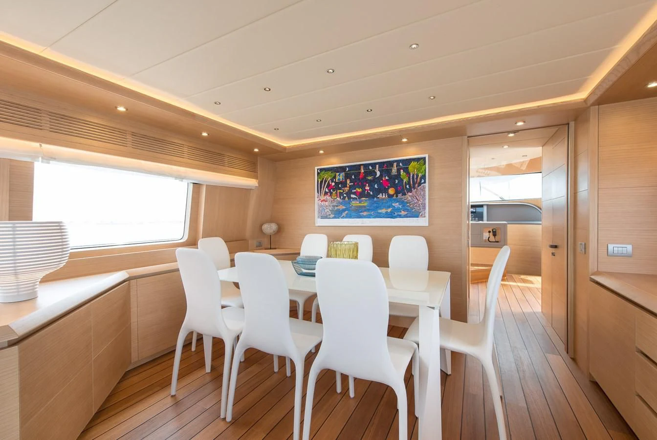 a room with a table and chairs aboard MIREDO Yacht for Sale