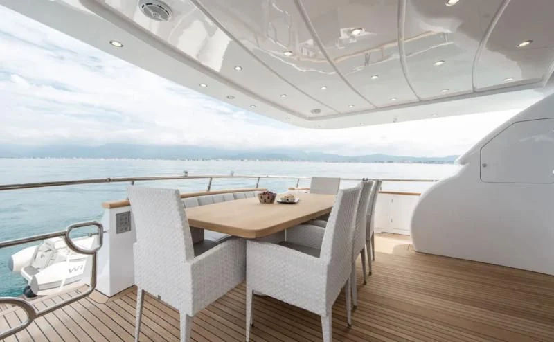 a room with a table and chairs aboard MIREDO Yacht for Sale