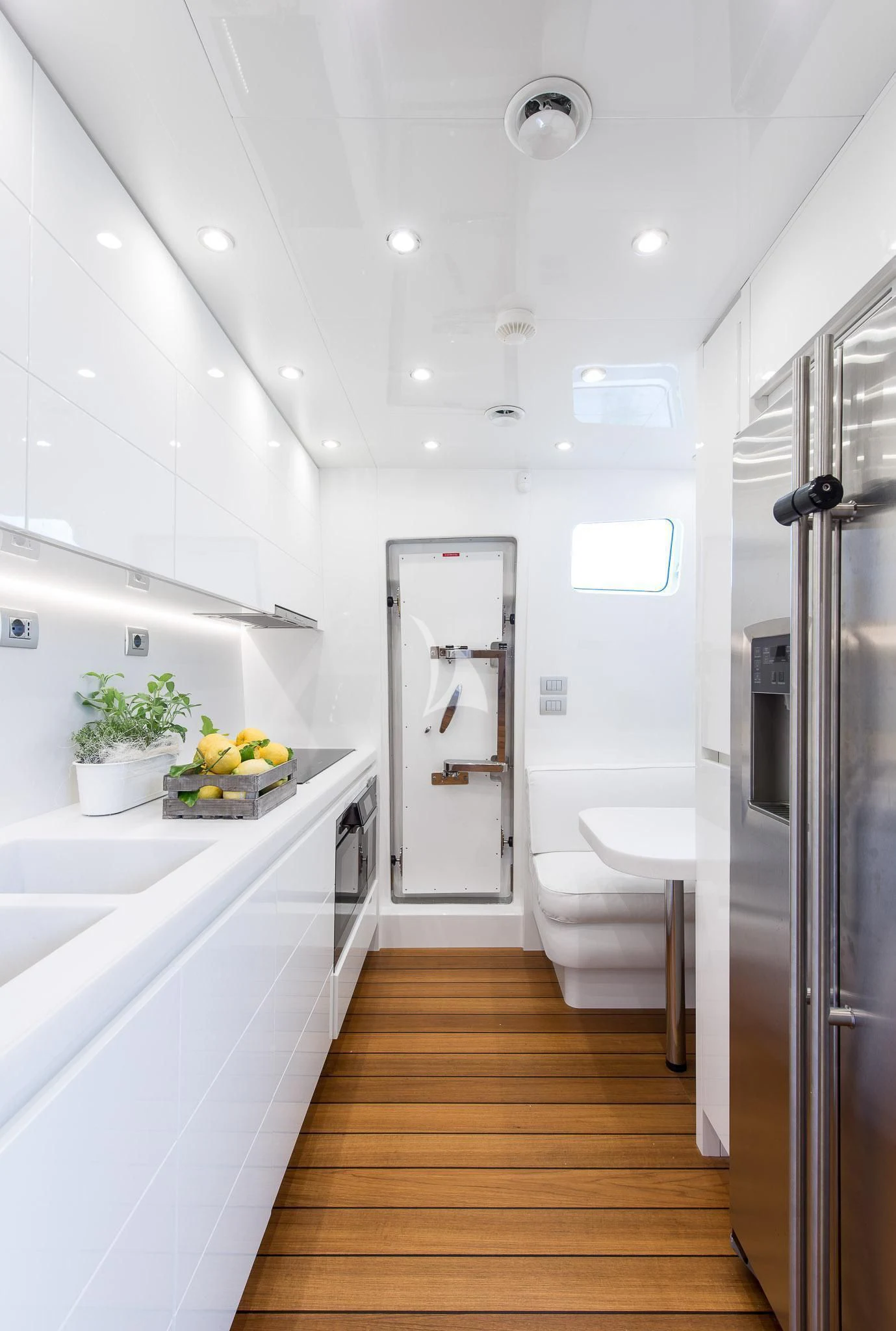 a kitchen with a large refrigerator aboard MIREDO Yacht for Sale