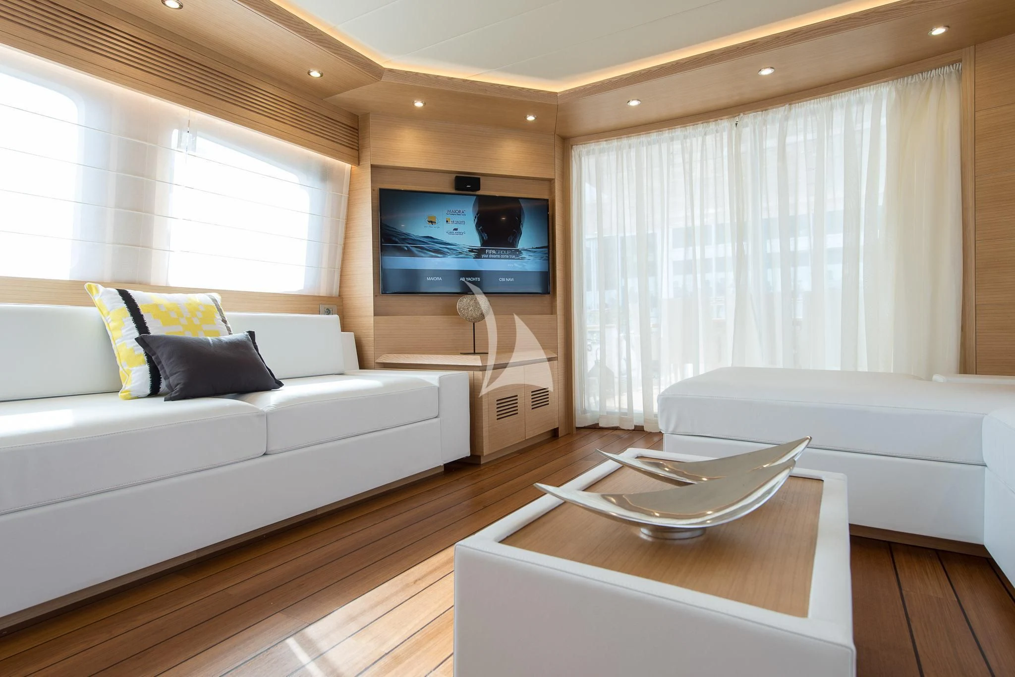 a living room with a couch and a television aboard MIREDO Yacht for Sale