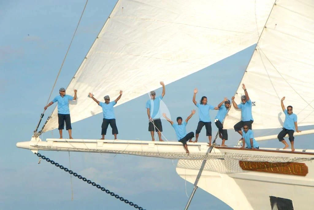 a group of people jumping on a sailboat aboard MUTIARA LAUT Yacht for Sale