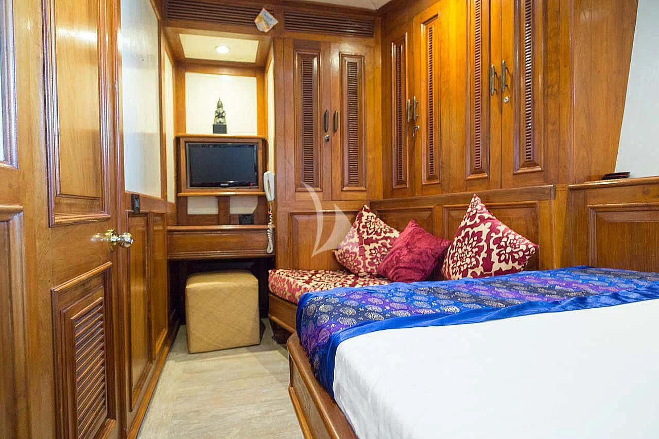 a bedroom with a bed and a television aboard MUTIARA LAUT Yacht for Sale