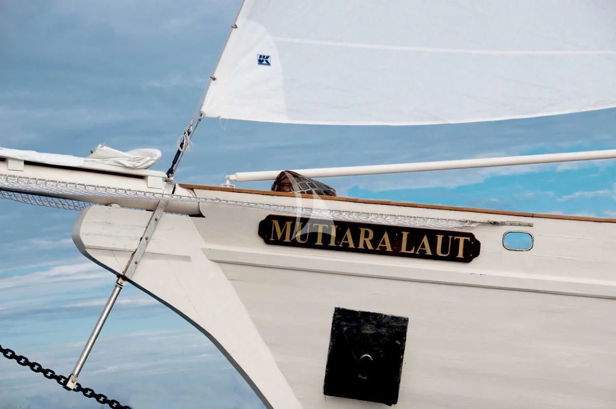 a white boat with a black and yellow label on it aboard MUTIARA LAUT Yacht for Sale