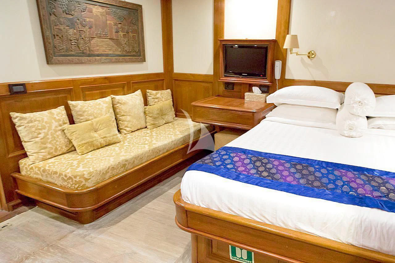 a room with a bed and a television aboard MUTIARA LAUT Yacht for Sale
