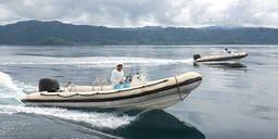 a person driving a boat on the water aboard MUTIARA LAUT Yacht for Sale