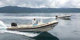 a person driving a boat on the water aboard MUTIARA LAUT Yacht for Sale