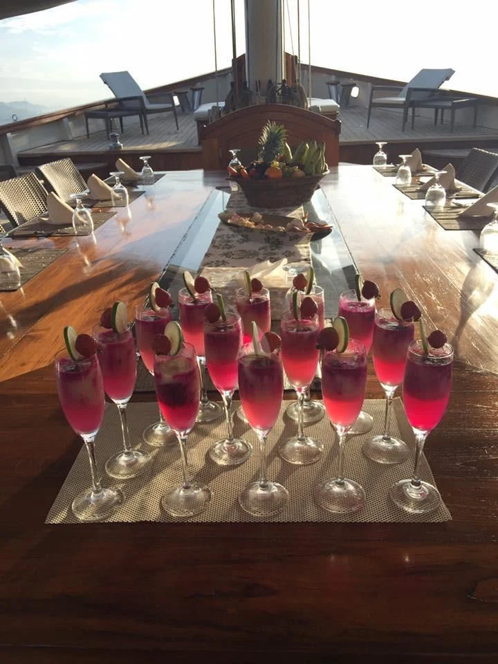 a group of glasses with red liquid in them aboard MUTIARA LAUT Yacht for Sale