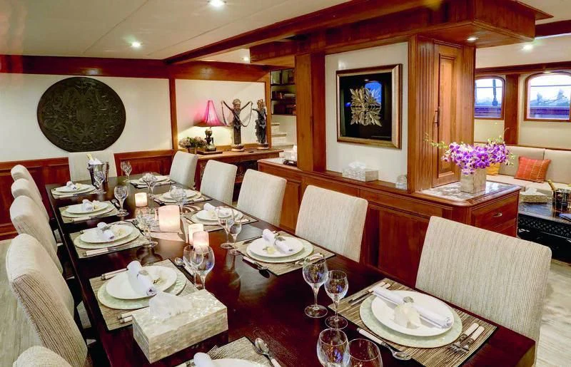 a dining room with a table set aboard MUTIARA LAUT Yacht for Sale