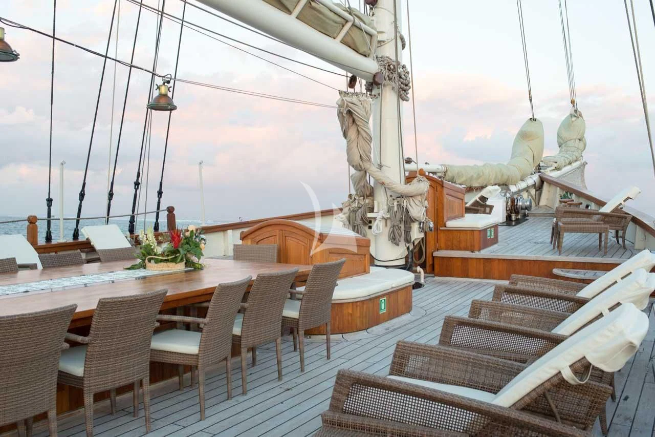 a large room with tables and chairs aboard MUTIARA LAUT Yacht for Sale