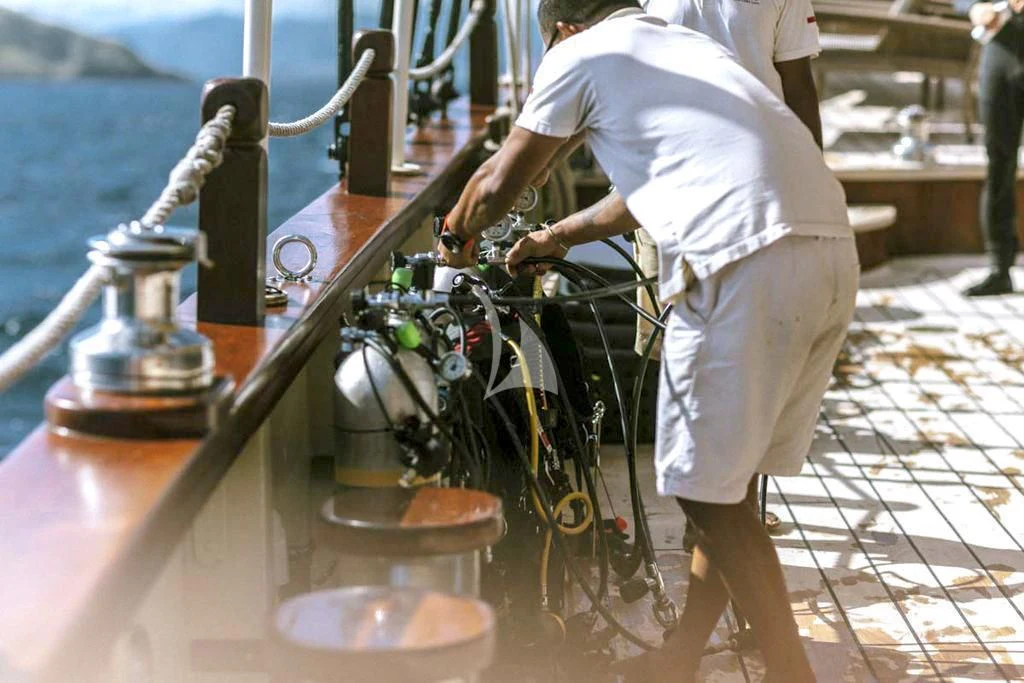 a man working on a machine aboard MUTIARA LAUT Yacht for Sale