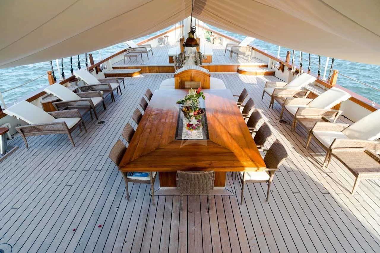 a room with a table and chairs aboard MUTIARA LAUT Yacht for Sale