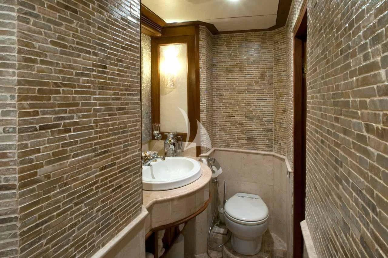 a bathroom with a toilet sink and a mirror aboard MUTIARA LAUT Yacht for Sale