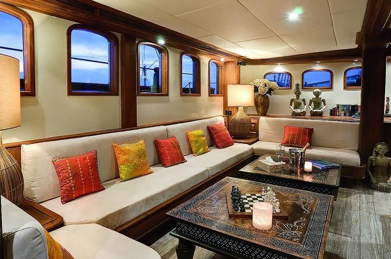 a living room with a large white couch and a coffee table aboard MUTIARA LAUT Yacht for Sale