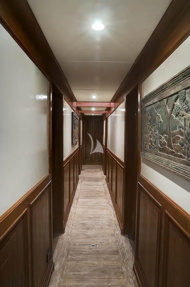 a wooden walkway with wood railings aboard MUTIARA LAUT Yacht for Sale