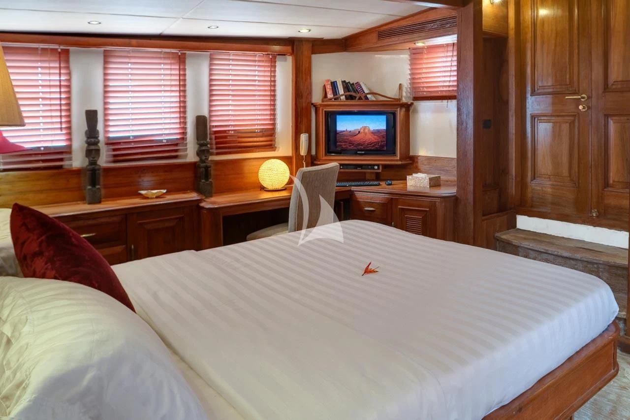 a bedroom with a bed and a television aboard MUTIARA LAUT Yacht for Sale