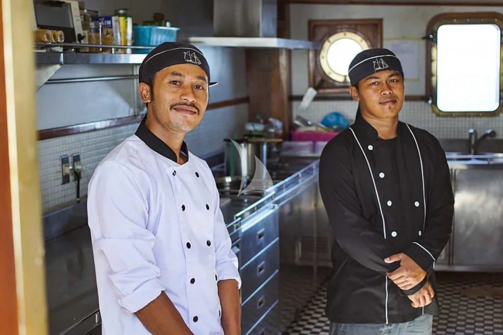 a couple of men standing in a kitchen aboard MUTIARA LAUT Yacht for Sale