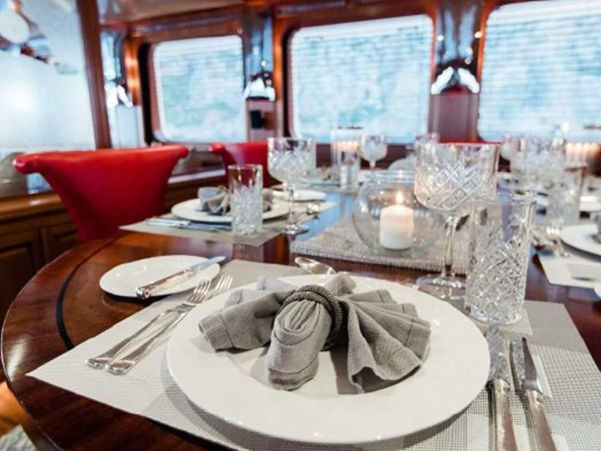 a table set with place settings aboard CHARISMA Yacht for Sale