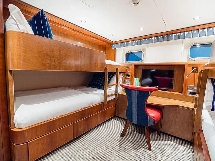 a bunk bed with a desk and chair aboard CHARISMA Yacht for Sale