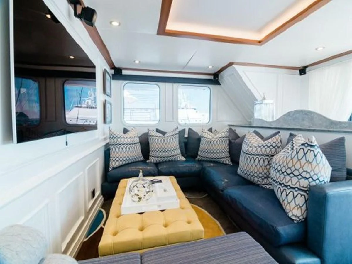 a blue couch with pillows aboard CHARISMA Yacht for Sale
