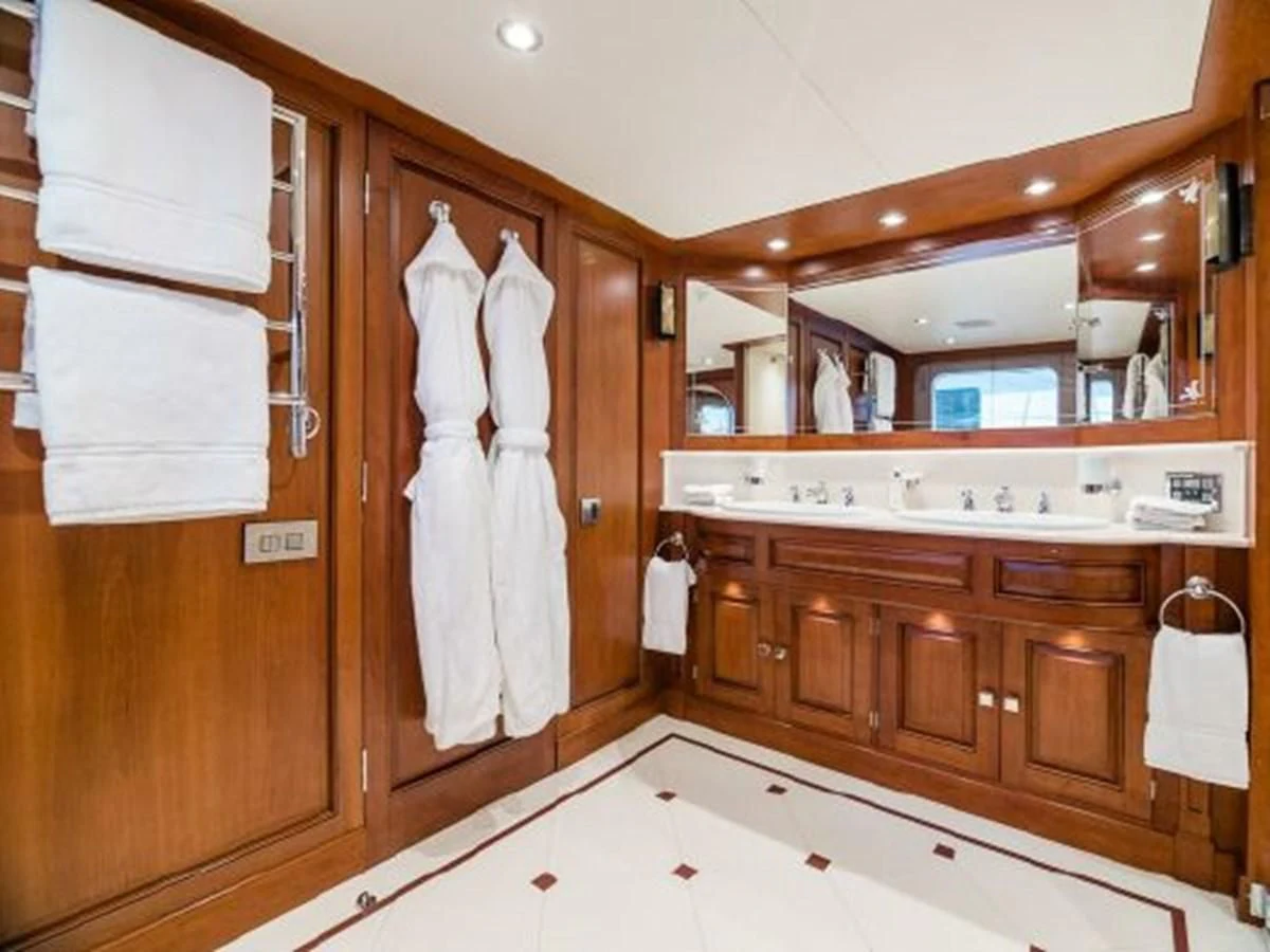 a bathroom with wooden cabinets aboard CHARISMA Yacht for Sale