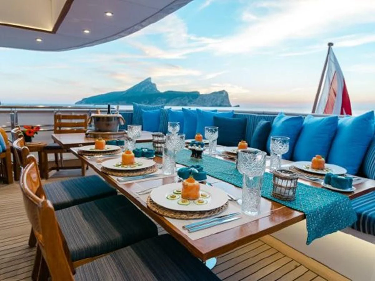 a table with food and drinks on it aboard CHARISMA Yacht for Sale
