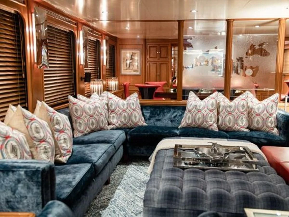 a living room with a couch and a table aboard CHARISMA Yacht for Sale