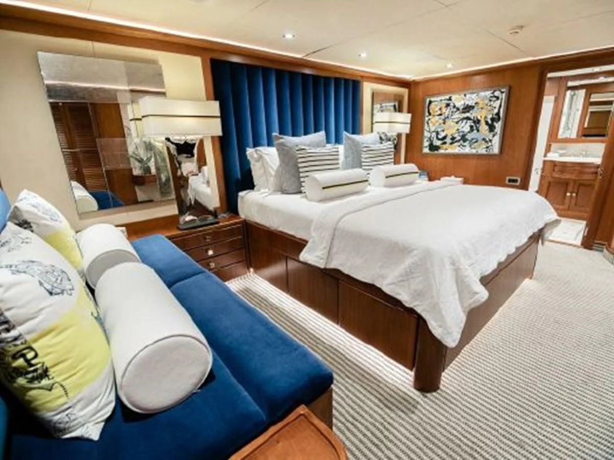 a bedroom with a bed and a couch aboard CHARISMA Yacht for Sale