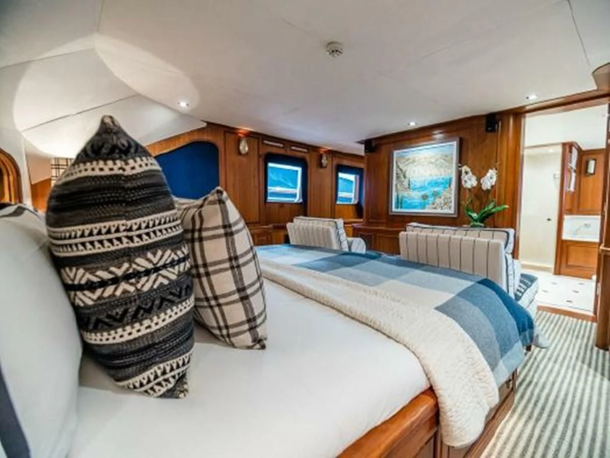 a bedroom with a bed and a pillow aboard CHARISMA Yacht for Sale