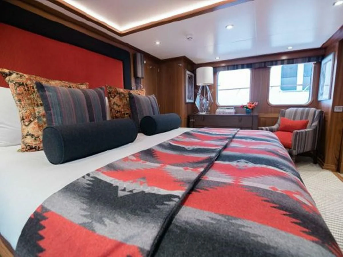 a bedroom with a large bed aboard CHARISMA Yacht for Sale
