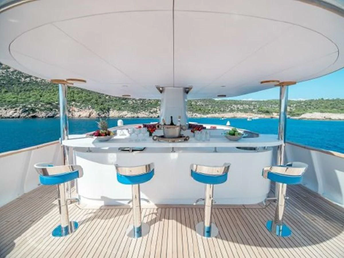 a table on a deck aboard CHARISMA Yacht for Sale