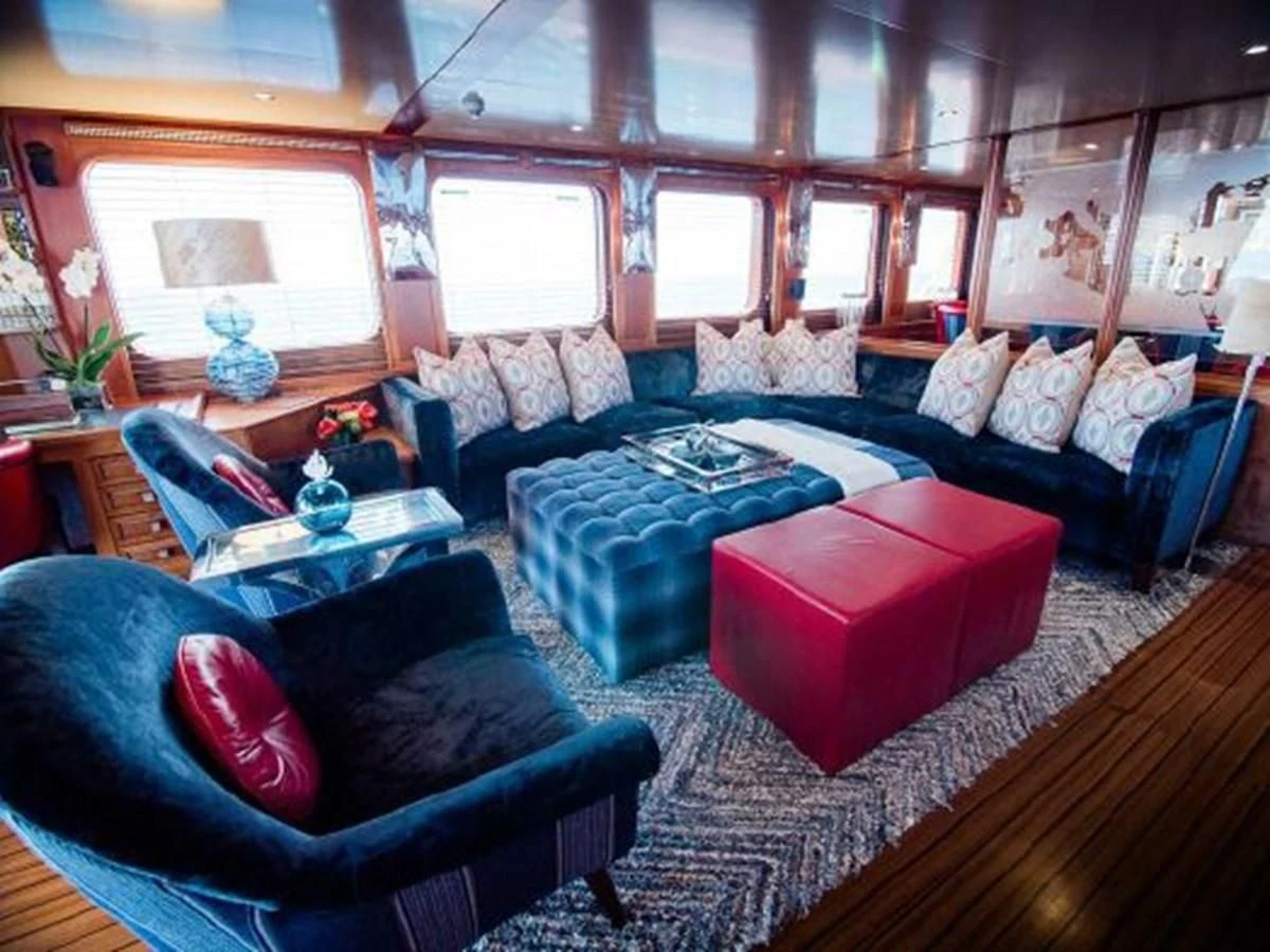 a living room with a couch and a table aboard CHARISMA Yacht for Sale