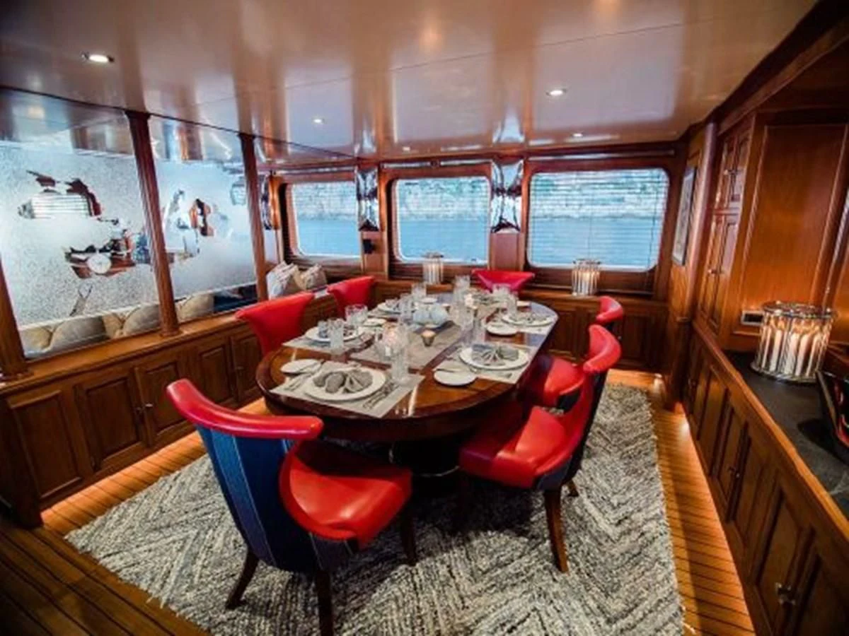 a dining room with a table and chairs aboard CHARISMA Yacht for Sale