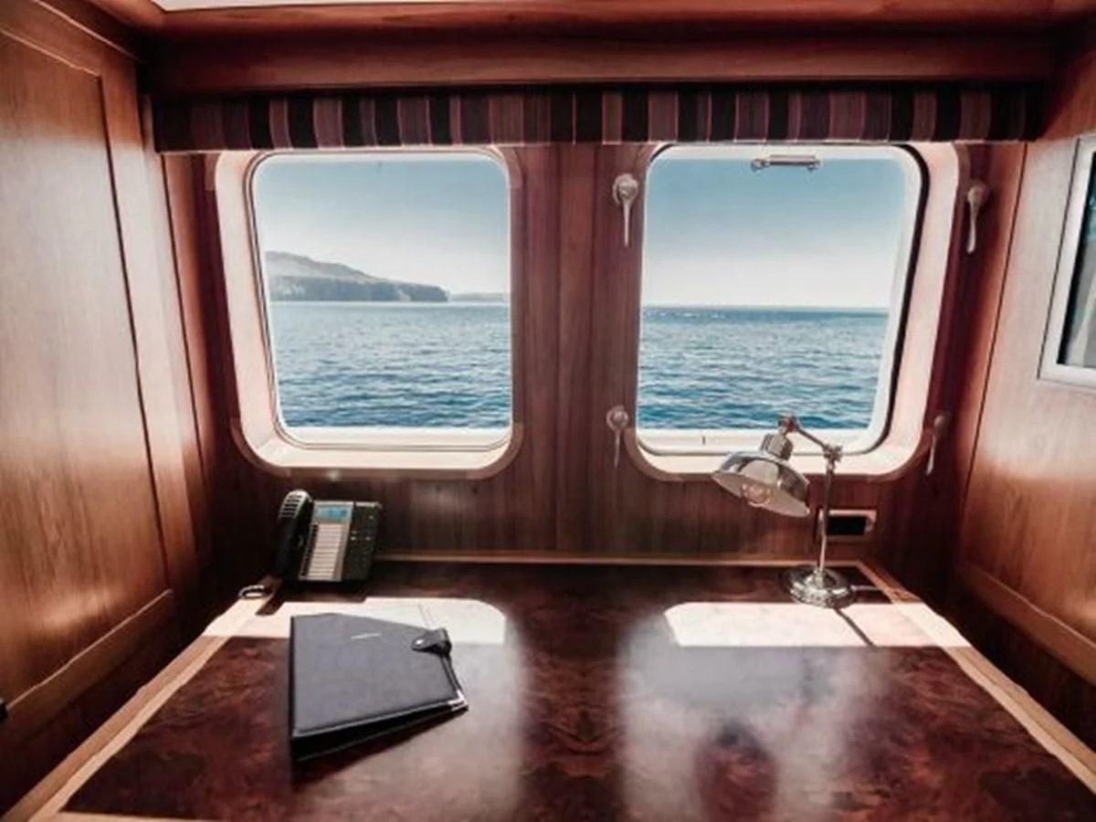 a laptop on a table aboard CHARISMA Yacht for Sale