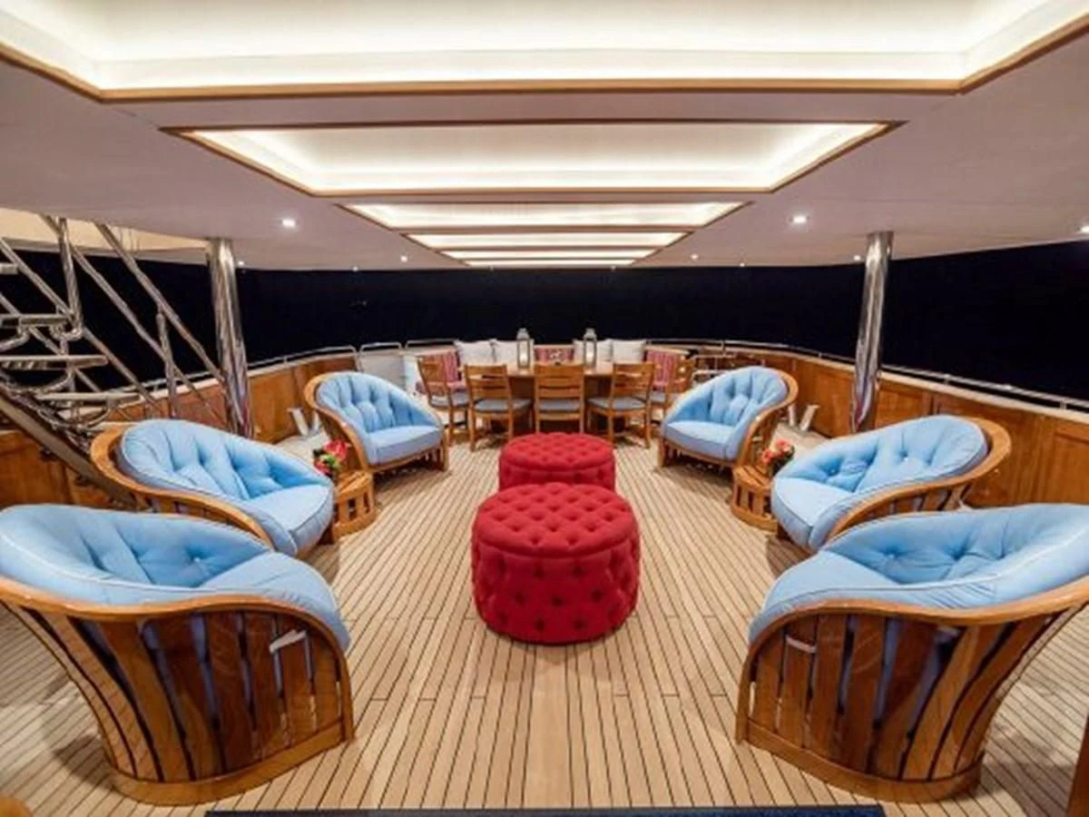 a large room with a group of couches and a slide aboard CHARISMA Yacht for Sale