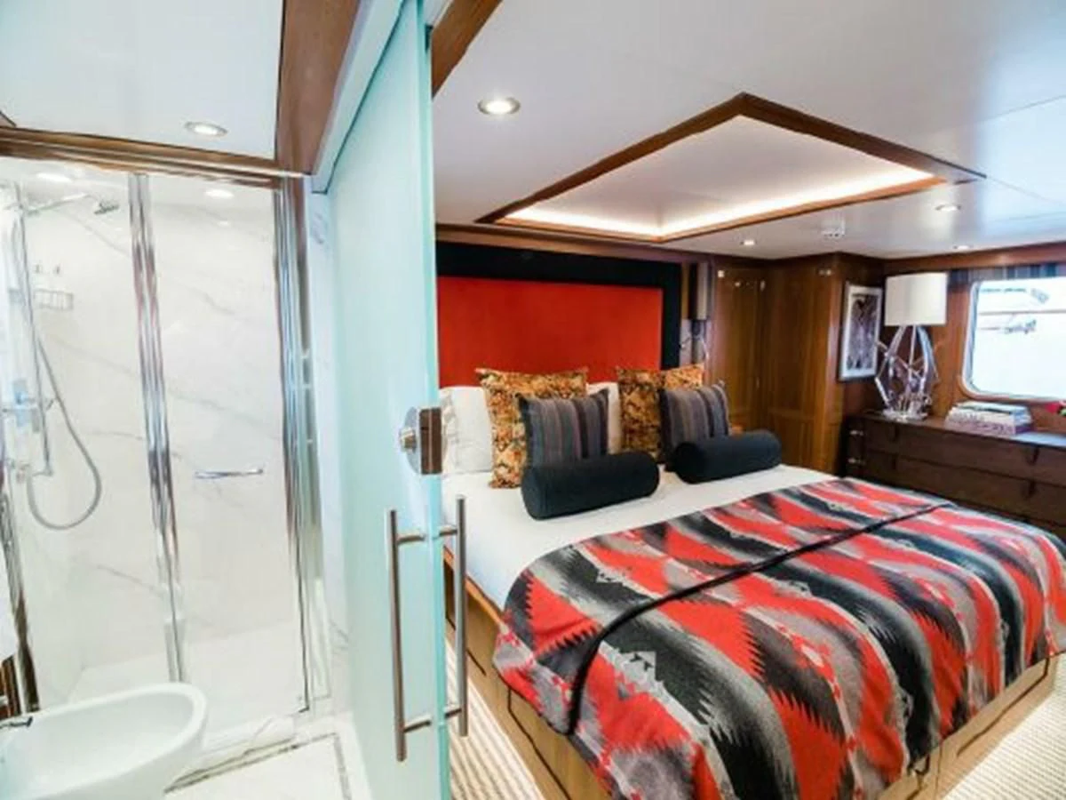 a bedroom with a bed and a window aboard CHARISMA Yacht for Sale