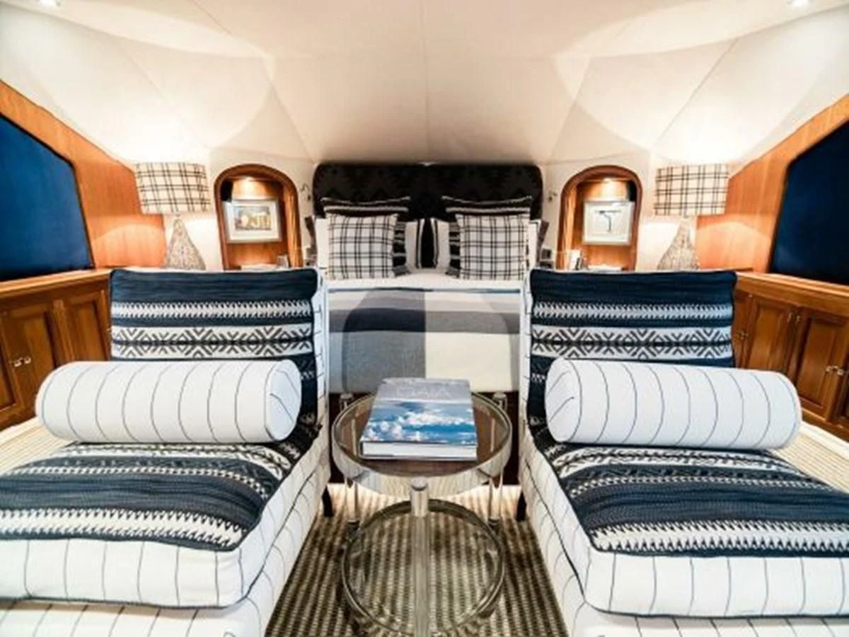 a room with a couple of couches and a table aboard CHARISMA Yacht for Sale
