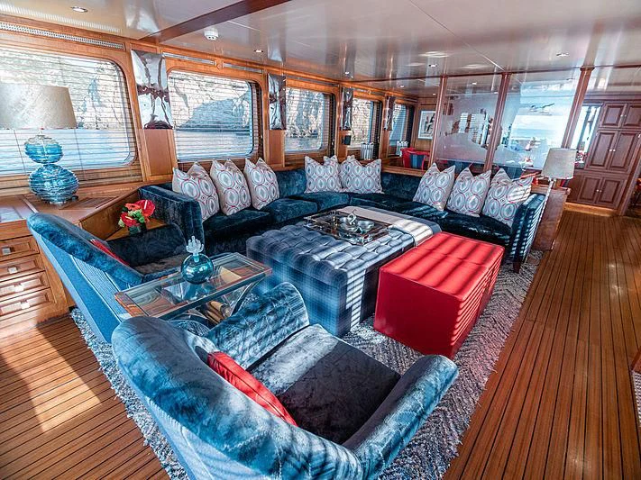 a living room with a large couch aboard CHARISMA Yacht for Sale
